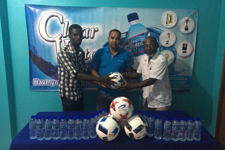 IPA Sales & Marketing Manager Ravel Seer (centre) hands over the balls to Tournament Co-coordinator Lennox Arthur (right), in the presence of Mahaicony representative Bertland Sobers