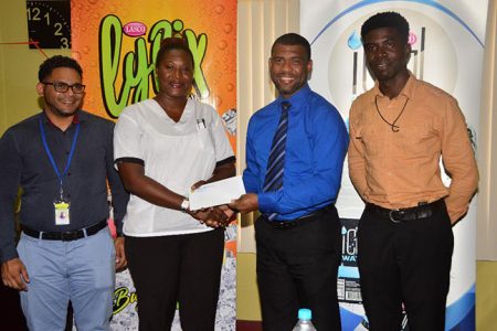 Non-Alcoholic brand Manager Errol Nelson (2nd from right) presents the sponsorship to Jackie Boodie of Petra Organisation, while Brand co-ordinator Fharis Mohamed (left) and Mark Alleyne of Petra Organisation look on.