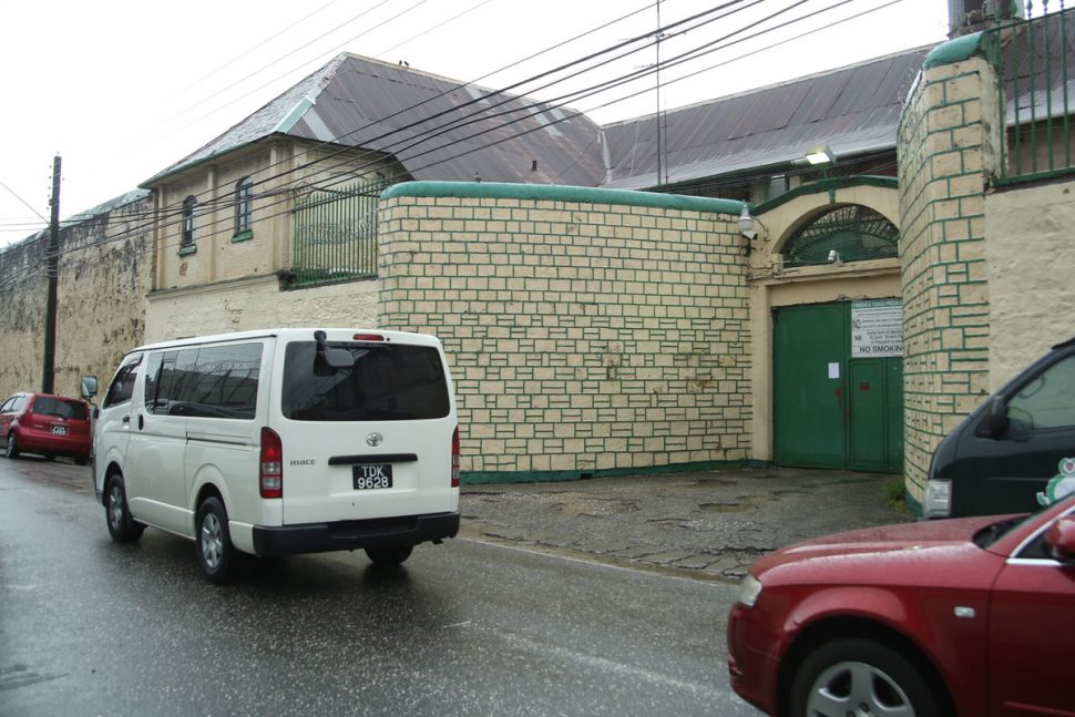 Vehicles pass by the Port-of-Spain prison on Frederick Street yesterday.