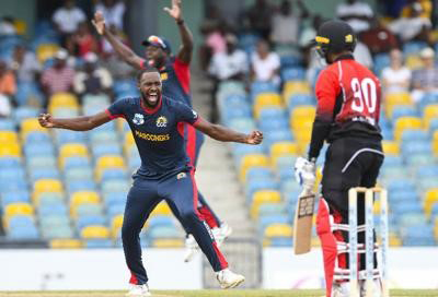 Combined Campuses and Colleges Marooners’ fast-bowler Akeem Jordan, left, celebrates the dismissal of Trinidad and Tobago Red Force skipper Denesh Ramdin during the second Super50 Cup semifinal at Kensington Oval, Barbados, yesterday. —Photo: CWI Media
