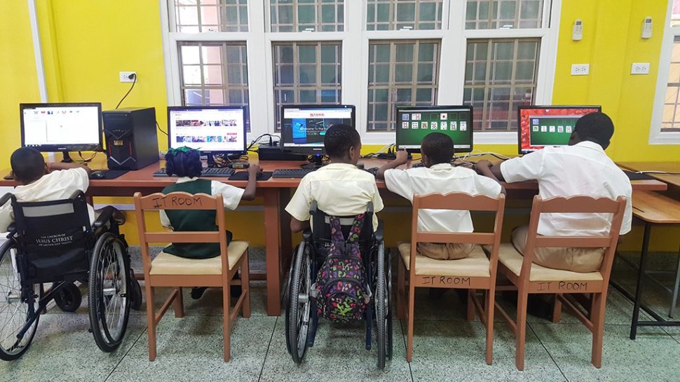 In photograph, students of the Ptolemy Reid Rehabilitation Centre utilising the donated smart lab.