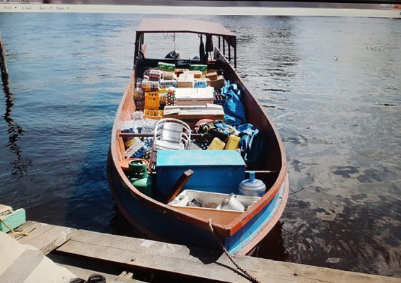 The boat in which the illegal items were found. Inset is the unlicensed 12-gauge shotgun that was discovered concealed in the bow