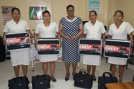 Minister of Public Health, Volda Lawrence (centre) and the CHWs who collected their tool kits on Friday. (DPI photo)
