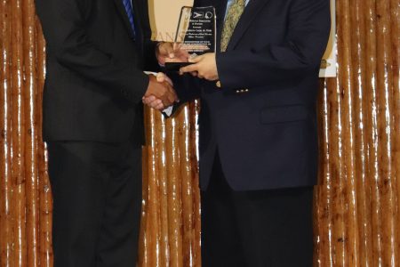 President of the AAG Aubrey Hutson (left) honours South America Consudatle’s President Roberto De Melo (Romario Samaroo)
