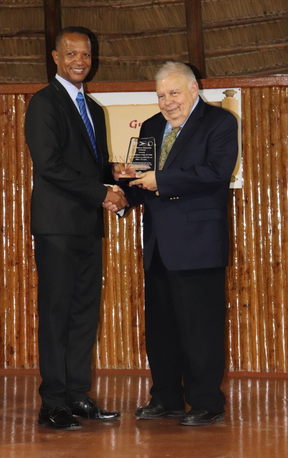 President of the AAG Aubrey Hutson (left) honours South America Consudatle’s President Roberto De Melo (Romario Samaroo)
