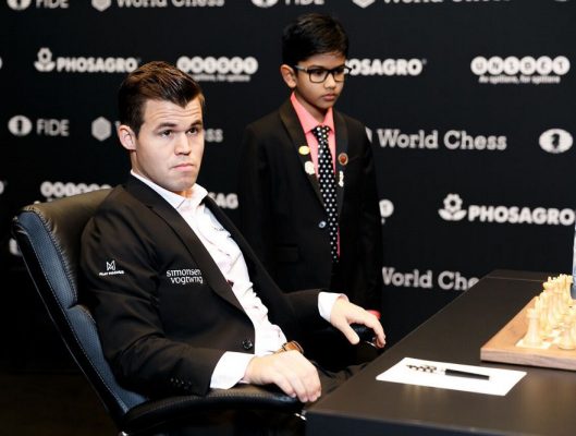 World chess champion Magnus Carlsen with the 9-year-old Indian-origin chess prodigy Shreyas Royal, who was given the significant honour of making one of the first moves of the 2018 Carlsen-Caruana world championship chess match. He is ranked No 4 in the chess world within his age group. Royal won an immigration contest to remain in the UK recently, and played in the 2018 British Chess Championship. He has been described as a “national asset” by British newspaper, The Guardian. (Photo: Nikolai Dunaevsky/World Chess)
