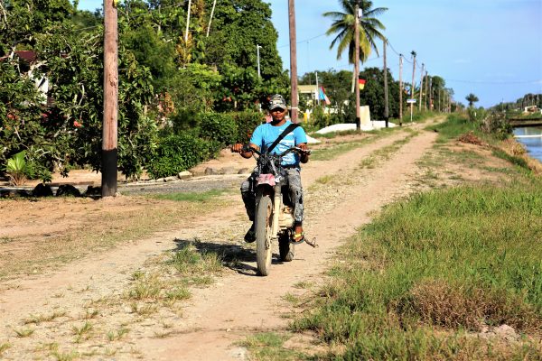  A man on his way to visit a relative. A dirt bike is probably the best vehicle with which to traverse the dam.