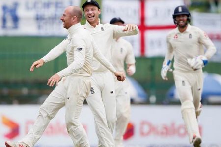 England’s Jack Leach (L) celebrates with his teammate Jos Buttler (C) after taking the wicket of Sri Lanka’s Malinda Pushpakumara (not pictured) and winning the match against Sri Lanka. REUTERS
