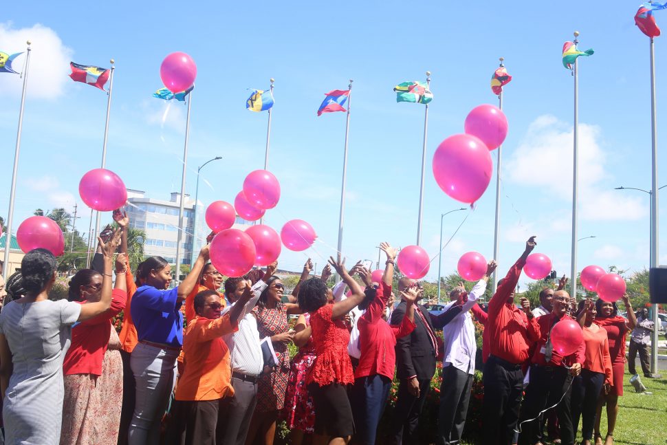 Staff of the CARICOM Secretariat releasing biodegradable helium balloons yesterday as they began ushering in the UN Women’s 16 Days of Activism against Gender-based Violence. See story on page 15. (Terrence Thompson photo)