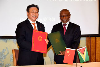 Foreign Affairs Minister Carl Greenidge (right) and China’s Ambassador to Guyana,  Cui Jianchun after the signing.