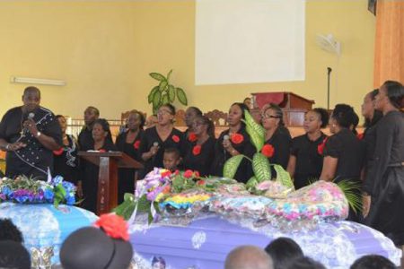 Members of the Green Heights Assembly of God congregation in Green Pond, St James, deliver a musical tribute during the funeral for 43-year-old Dionne Smith and her 16-year-old daughter, Jay-Shenel Gordon, at the Farm Heights Seventh-day Adventist Church in Farm Heights, St James, yesterday.