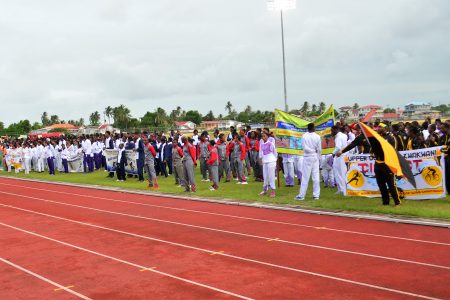 The athletes from the 15 competing districts paying attention to Minister of Education, Nicolette Henry during the opening ceremony of the 58th National Schools Cycling, Swimming and Track and Field Championships yesterday  at the National Track and Field Centre. (Orlando Charles photo)