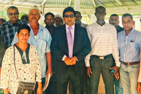 Attorney at law Anil Nandlall (in suit) with some of the aggrieved rice farmers shortly after the legal proceedings against them were withdrawn yesterday. Also in the photo (second from right) is PPP/C Member of Parliament Dharamkumar Seeraj.