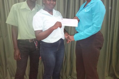 Michael and Ishabeth Sinclair receiving their cheque from Assistant Director of Youth, Leslyn Boyce. (Department of Public Information photo)