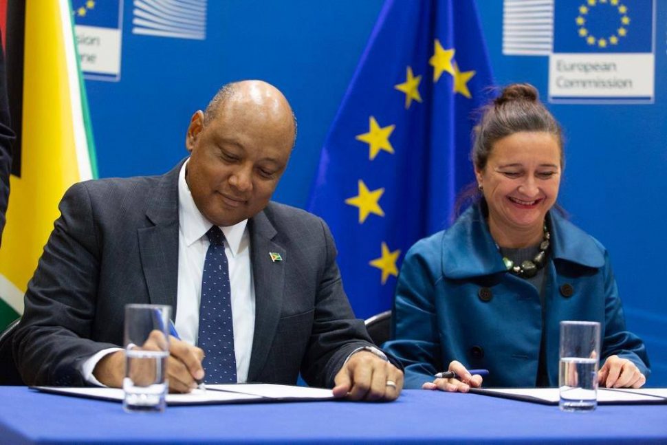 Minister of Natural Resources Raphael Trotman and Deputy Director General for the Directorate-General for International Cooperation and Development (DG DEVCO) Marjeta Jager initialling the agreement on Friday. (EU Delegation photo)