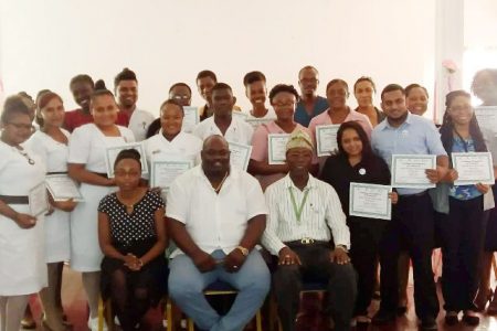 Director of Regional Health Services of Region Six, Jevaughn Andrew Stephen (seated at centre) and Lecturer/Senior Psychologist, Balogun O. Osunbiyi (seated at right) along with participants of the mental health training workshop. (DPI photo)