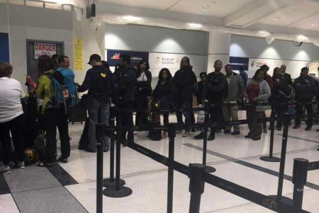 CAL passengers wait in line to get travel information for Flight BW601 on Saturday, after the flight was forced to return to the Pearson International Airport on Saturday morning, after encountering technical issues on the way to Trinidad.