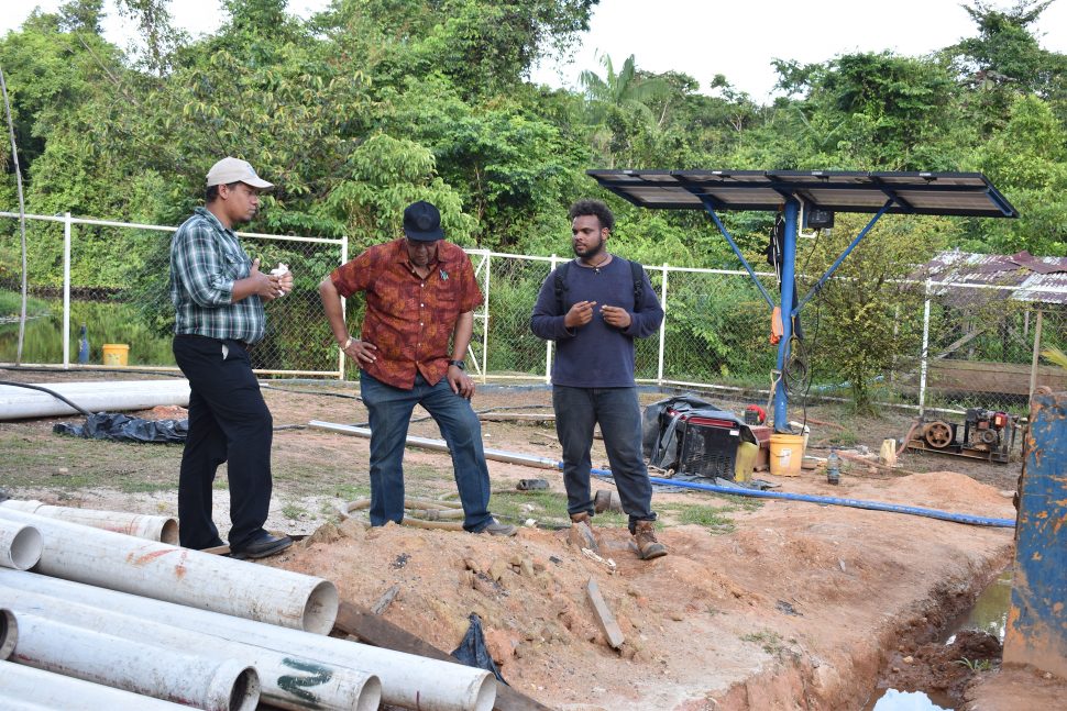 GWI’s Managing Director, Dr. Richard Van West-Charles (centre), Non-revenue water Coordinator, Carlos Rodrigues (left) and Hinterland Engineer, Jumal Duncan  assessing the progress of ongoing works in Port Kaituma. (GWI photo)