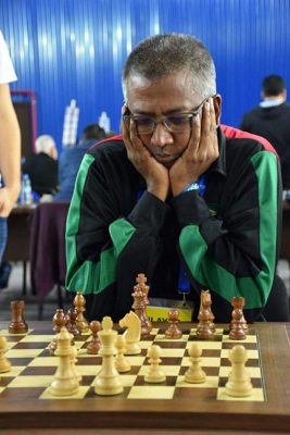 Loris Nathoo in deep concentration at the 2018 Chess Olympiad in Batumi, Georgia. Nathoo played Board Three for Guyana against the finest third boards worldwide. One hundred and eight-three countries contested the Olympiad with China taking gold in the men’s and women’s categories. 
