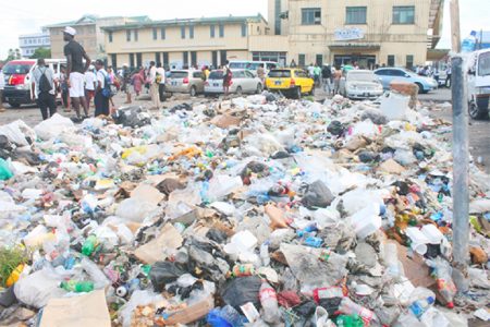 Garbage piled up outside Stabroek Market during a previous city garbage collection crisis in 2013. (Stabroek News file photo)