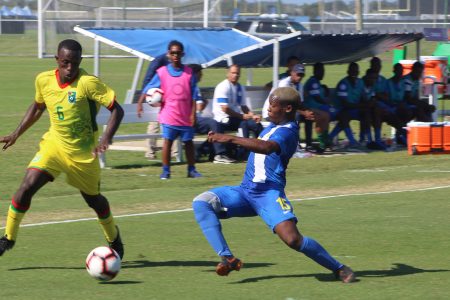 Rogyear Anita [right] of Curacao attempting a challenge on Lionel Holder [no.6] of Guyana at the IMG Academy, Florida, USA in the CONCACAF Men’s U20 Championship
