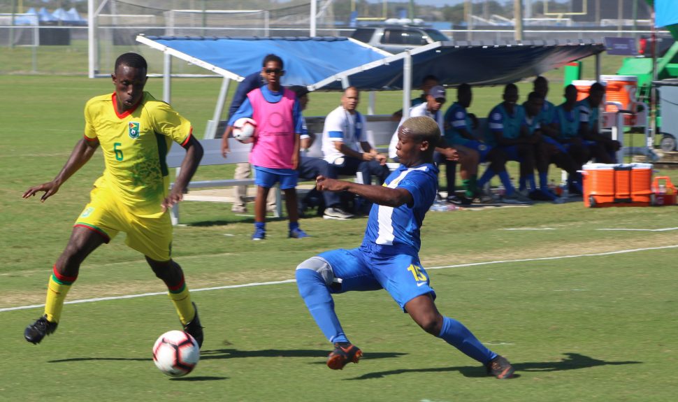Rogyear Anita [right] of Curacao attempting a challenge on Lionel Holder [no.6] of Guyana at the IMG Academy, Florida, USA in the CONCACAF Men’s U20 Championship
