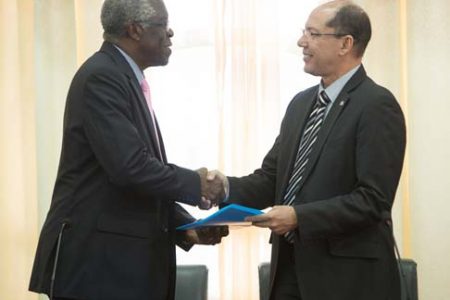 Director-General, Guyana Civil Aviation Authority, Retired Lieutenant Colonel, Egbert Field (left) and Acting Director-General, Department of Civil Aviation, Aruba, Anthony Kirchner exchanging the MOU. (DPI photo)
