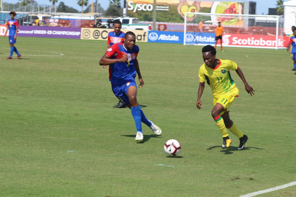 Goal Scorer Kelsey Benjamin (right) of Guyana trying to race away from the pursuing Akeem Hyde of Cayman Islands during their matchup in the CONCACAF Men’s U20 Championship at the IMG Academy in Florida, USA
