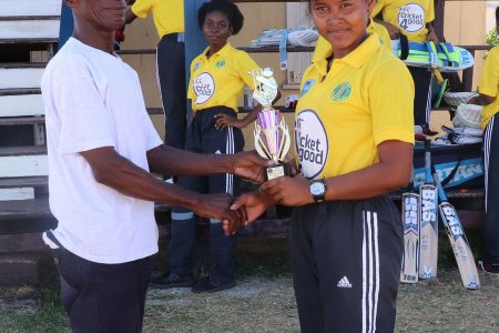 Player of the match, Lisa Charles receives her award from President of the West Berbice Cricket Association David Black.