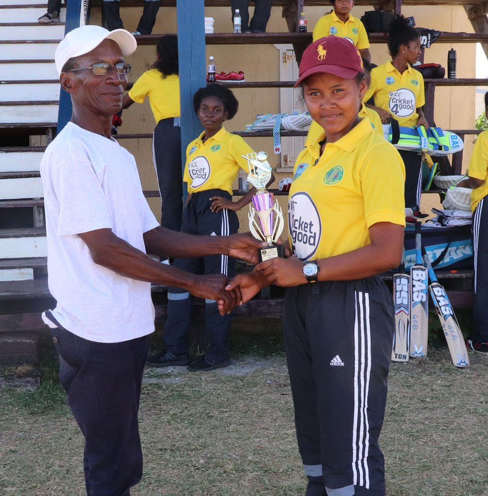 Player of the match, Lisa Charles receives her award from President of the West Berbice Cricket Association David Black.