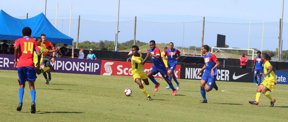 Guyana’s Kelsey Benjamin [centre] on the attack against the Cayman Islands at the IMG Academy in Florida, USA in the CONCACAF Men’s U20 Championship.