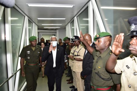 President David Granger (second from left) on arrival last night  at the Cheddi Jagan International Airport, Timehri.  Following chemotherapy he is wearing a mask to guard against infection. (Ministry of the Presidency photo)