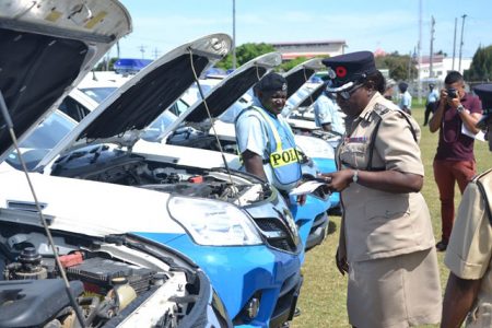 Deputy Commissioner of Operations of the Guyana Police Force, Maxine Graham conducting the first inspection of the Chinese-donated vehicles at the Eve Leary Ground yesterday. (Department of Public Information photo)
