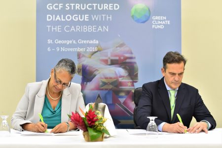 Monica La Bennett, Vice-President (Operations), CDB (left) and Javier Manzanares, Executive Director ad interim, GCF signing the AMA in Grenada on November 9, 2018.  (CDB photo)