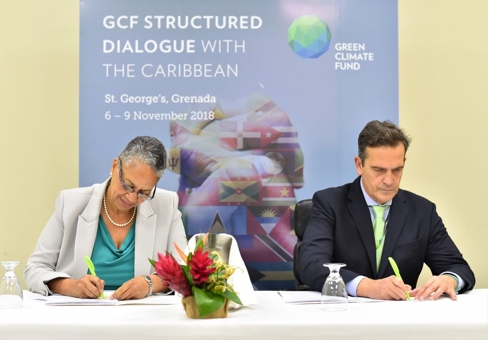 Monica La Bennett, Vice-President (Operations), CDB (left) and Javier Manzanares, Executive Director ad interim, GCF signing the AMA in Grenada on November 9, 2018.  (CDB photo)


