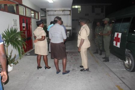 Deputy Commissioners Paul Williams DSM (right) and Maxine Graham DSM (left), along with ranks from the Guyana Defence Force at the St. Joseph Mercy Hospital on Tuesday night, when the injured cop arrived.