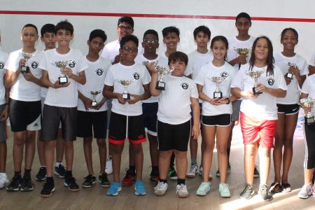  Participants in this year’s Farfan & Mendes Junior Skill level squash tournament display their trophies (Royston Alkins photo) 
