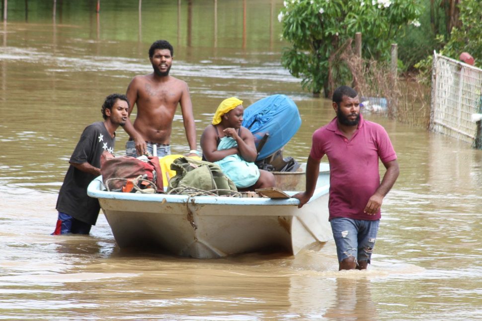 Residents of Lower Mafeking in Mayaro use a pirogue to rescue people who were stranded in their homes last month. 