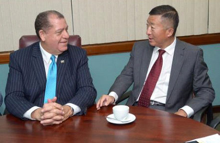 Audley Shaw (left), minister of commerce, agriculture and fisheries, in conversation with Chinese Ambassador Tian Qi while addressing members of the press last week.