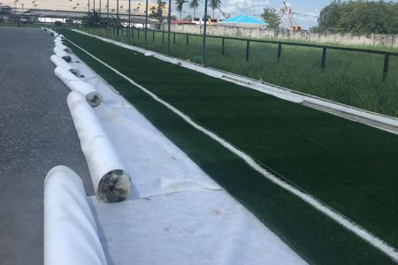 Sections of the artificial turf being laid at the Guyana Football Federation [GFF] National Training Centre