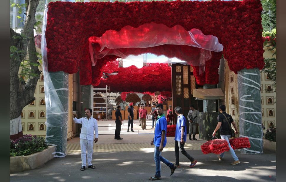 A man carries bunches of flowers to decorate Antilia, which is the house of Chairman of Reliance Industries Mukesh Ambani, ahead of his daughter’s wedding in Mumbai, India (Reuters/Francis Mascarenhas photo)