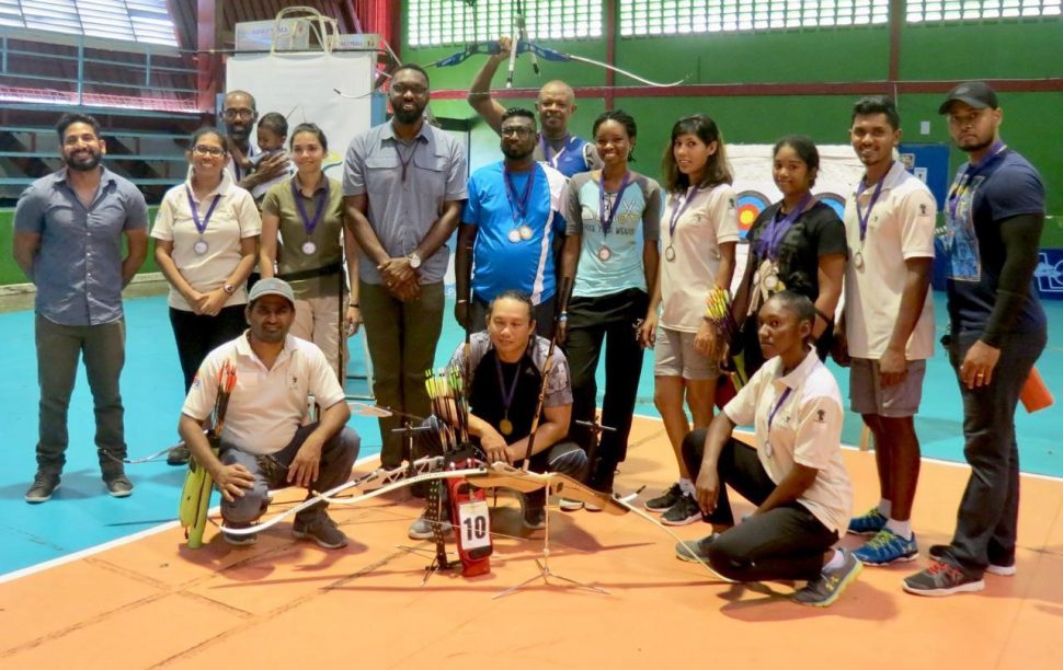Director of Sport, Christopher Jones (standing  fourth from left) and President of Archery Guyana, Mohamed Khan, (kneeling left) at 2018 Indoor Archery Finals at the National Gymnasium