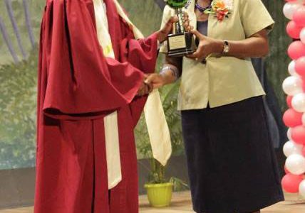 Valedictorian, Mr. Shurlun Tudor receiving one of his prizes from Director of NCERD, Mrs. Jennifer Cumberbatch. (Ministry of Education photo)
