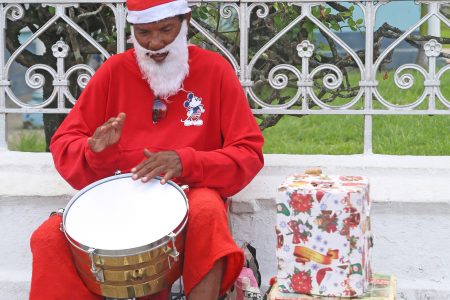 Lone drummer: This drumming Santa was creating his own rhythm on Avenue of the Republic yesterday.
