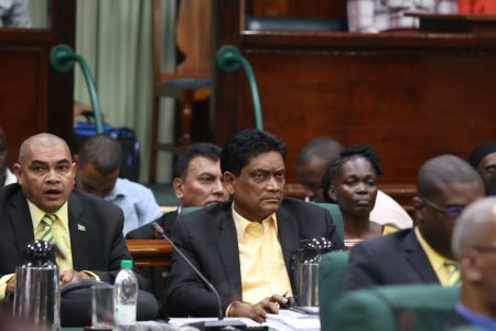 After the vote: APNU+AFC MP Charrandas Persaud (centre) with a tense look on his face moments after his vote on Friday in favour of a motion of no-confidence against the government.  (Terrence Thompson photo)
