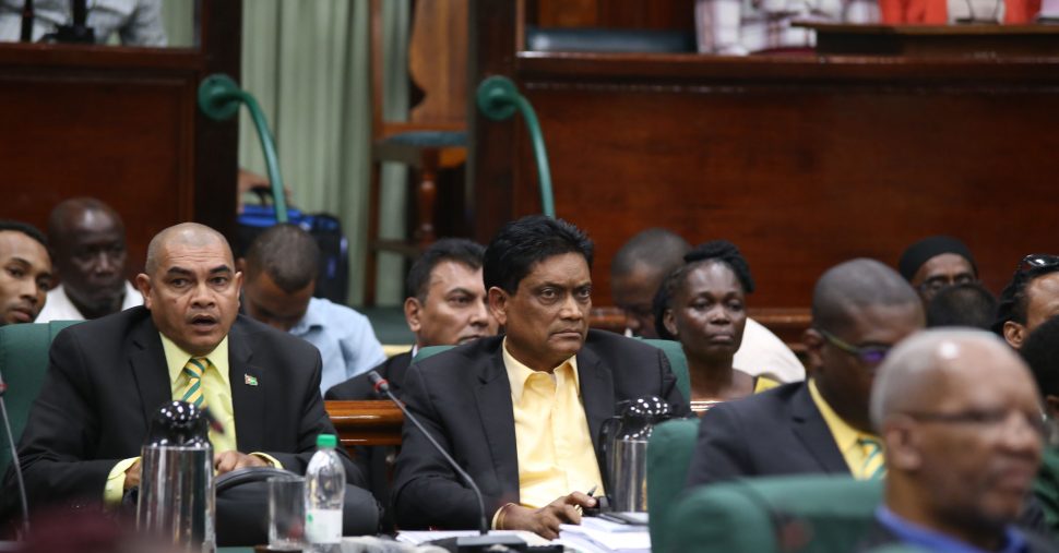 After the vote: APNU+AFC MP Charrandas Persaud (centre) with a tense look on his face moments after his vote on Friday in favour of a motion of no-confidence against the government.  (Terrence Thompson photo)
