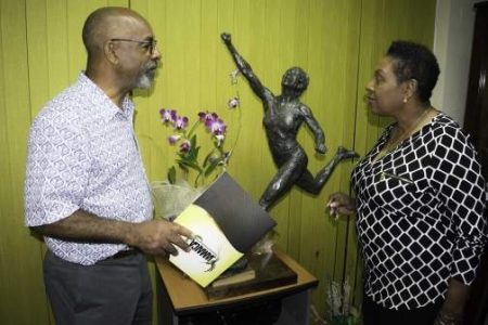 Jamaican Minister of Culture, Gender, Entertainment and Sport, Olivia Grange (right) discusses the design of the Shelly-Ann Fraser Pryce statue with sculptor Basil Watson. 