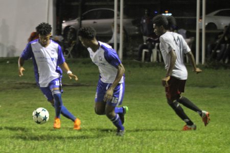 Action in the Turbo Knockout Football Championship finale between the Georgetown Football Club (in blue) and Northern Rangers at the Ministry of Education ground on Wednesday night. (Orlando Charles photo)

