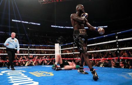 Deontay Wilder reacts after knocking down Tyson Fury Action Images via Reuters/Andrew Couldridge
