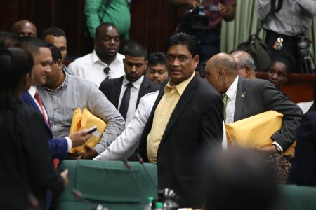 Former government MP Charrandass Persaud (at right in foreground) after his stunning vote in favour of the PPP/C’s motion of no-confidence against the government. (Terrence Thompson photo)
